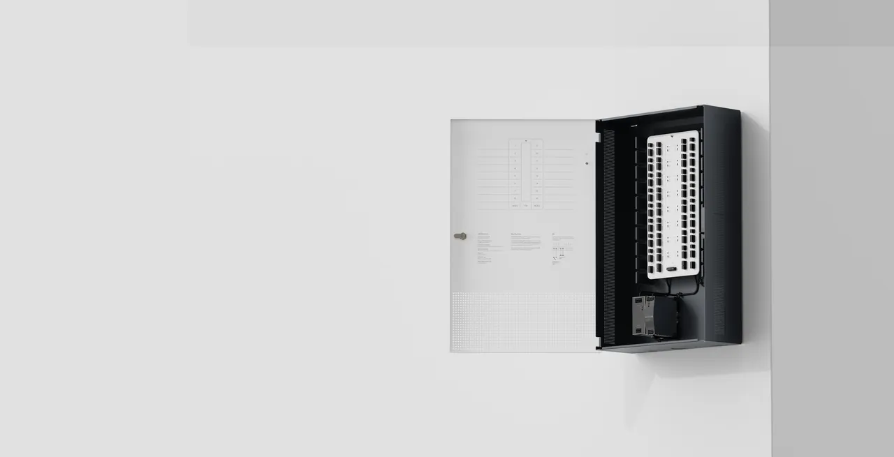 Verkada alarm control panel mounted on a wall with door open, showing internal components.