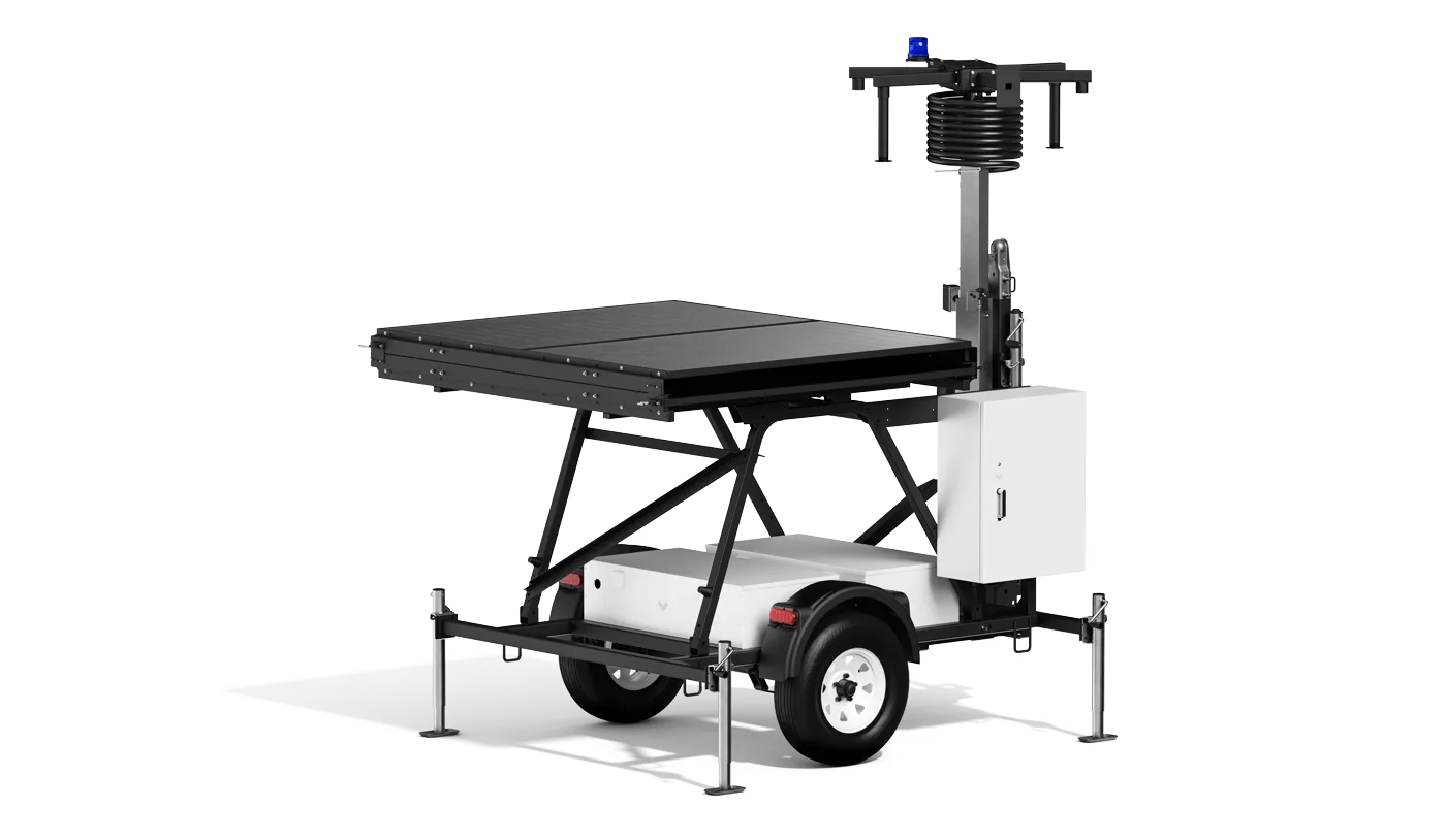 Mobile surveillance trailer with folded solar panels in its lowered towing configuration, ready to relocate to the next jobsite