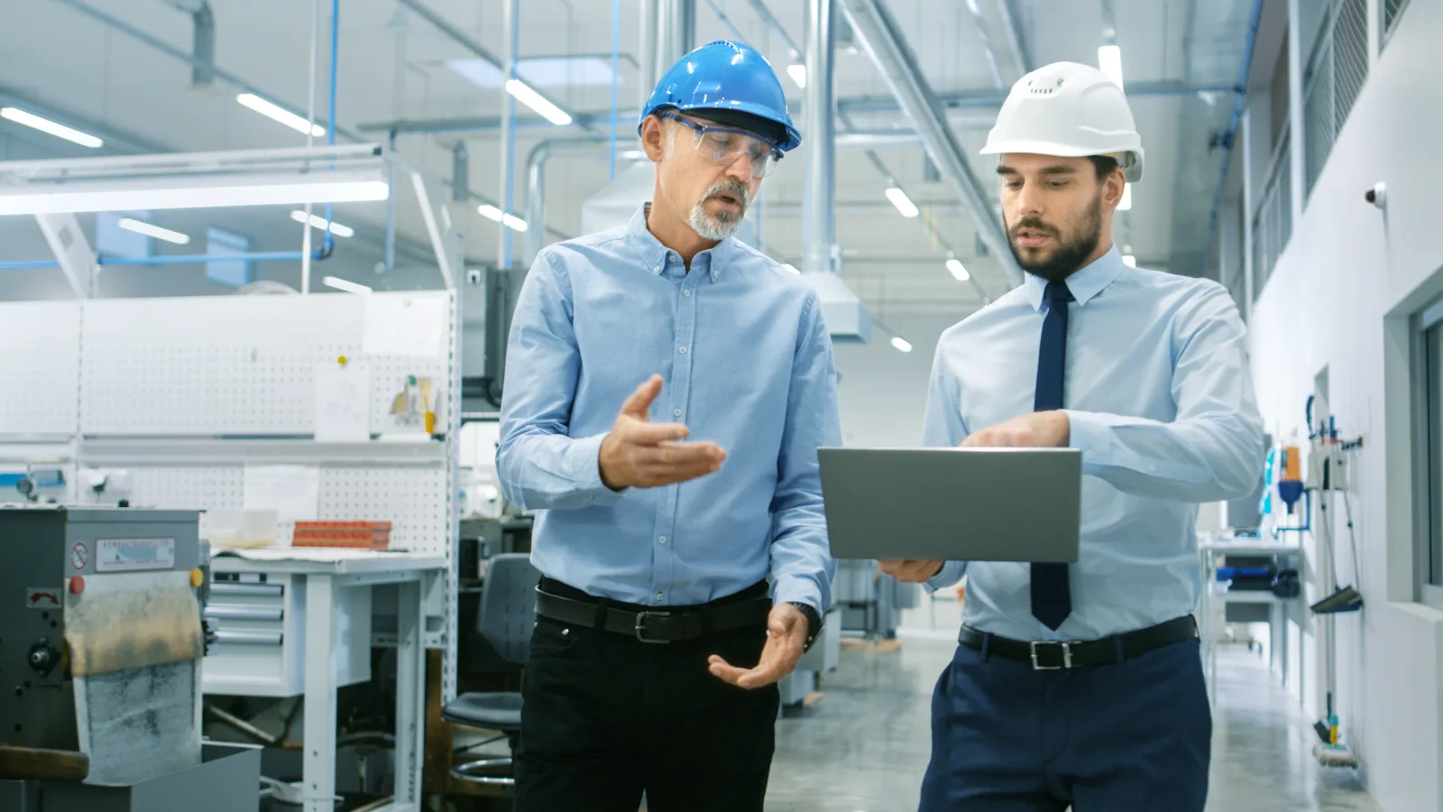 Monarch industrial security integrator walking a manufacturing plant floor with an operations director