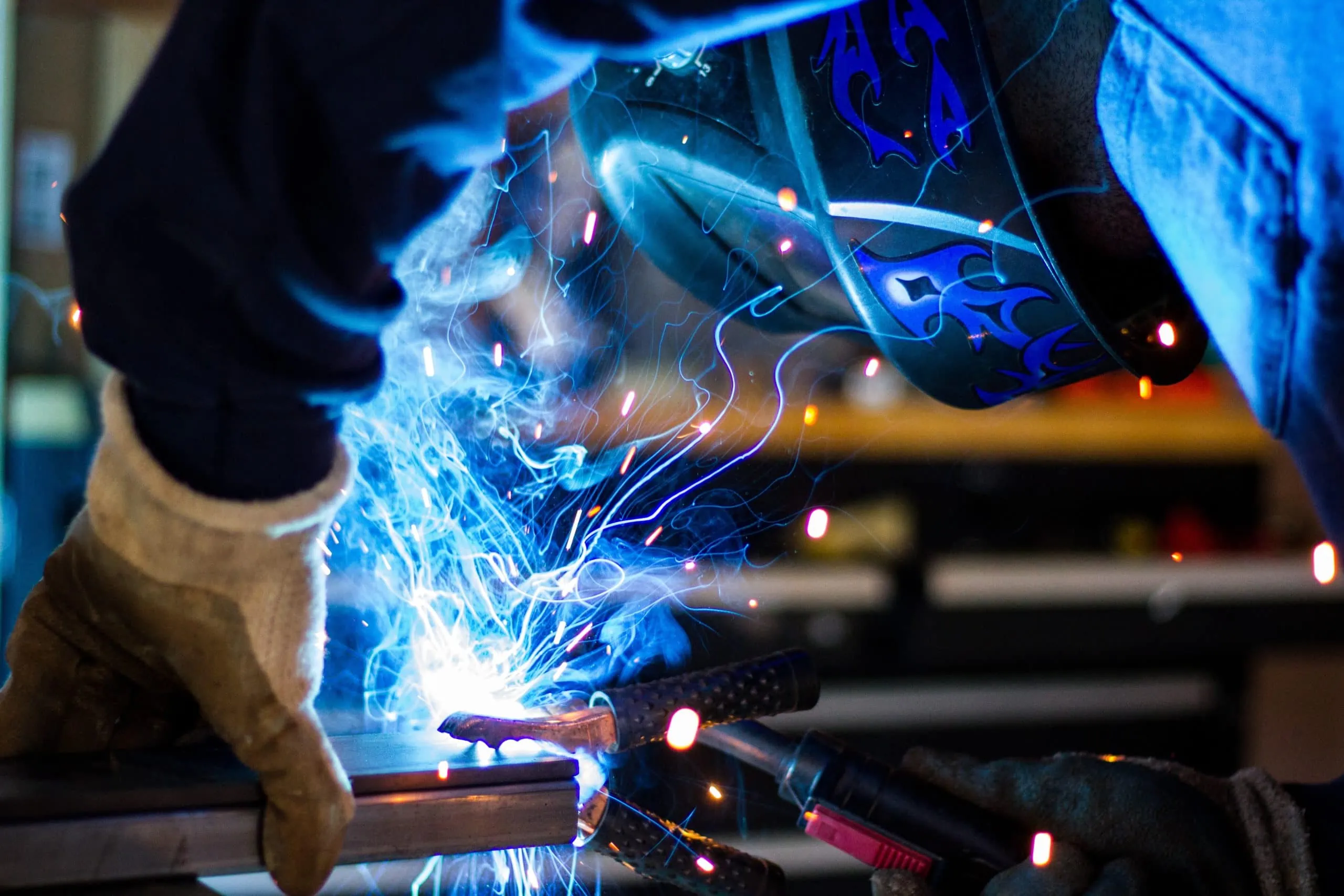 Man welding knows safety protocols ensured with security system manufacturers