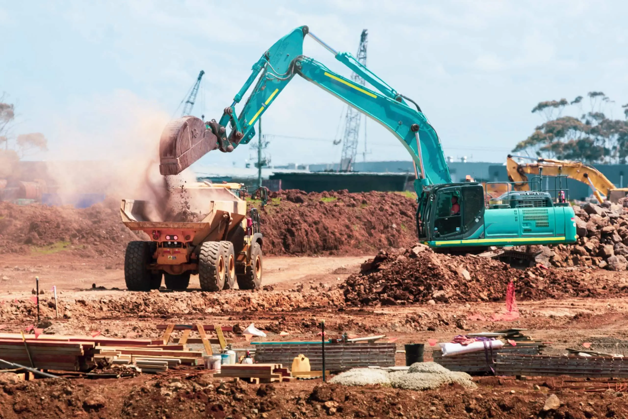 Construction equipment on worksite that is monitored by construction security camera