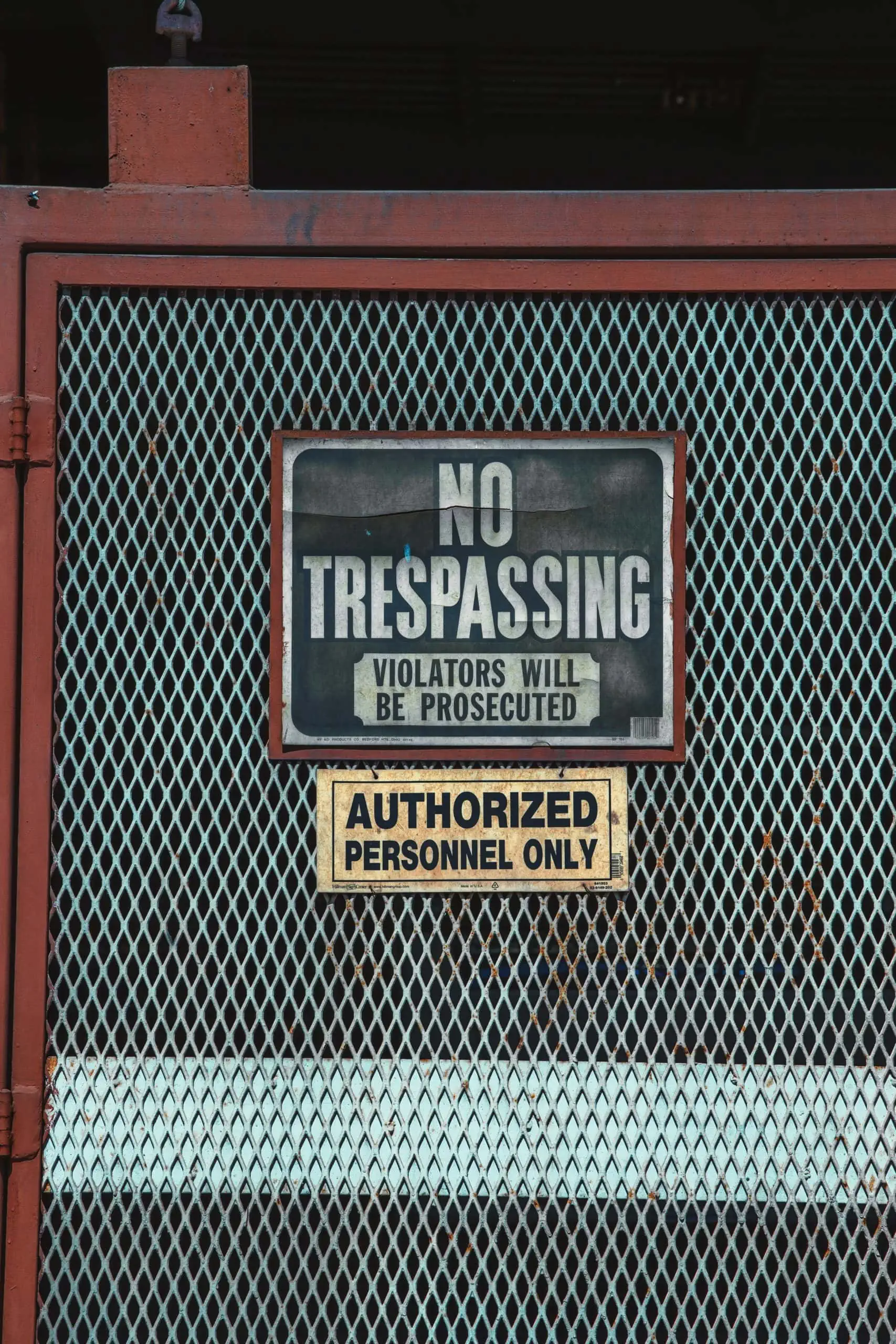 No trespassing sign on building that has Verkada long range surveillance camera