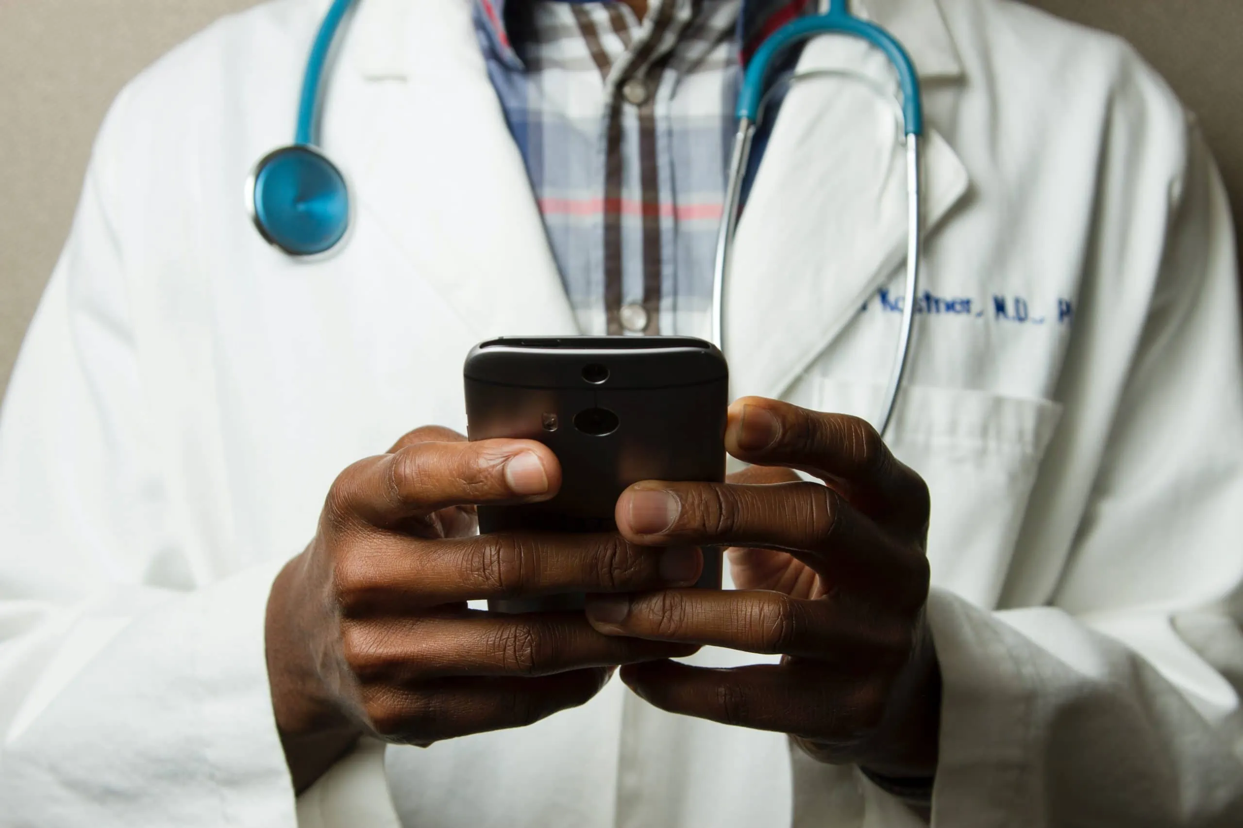 Doctor monitoring hospital insights using video analytics platform on phone