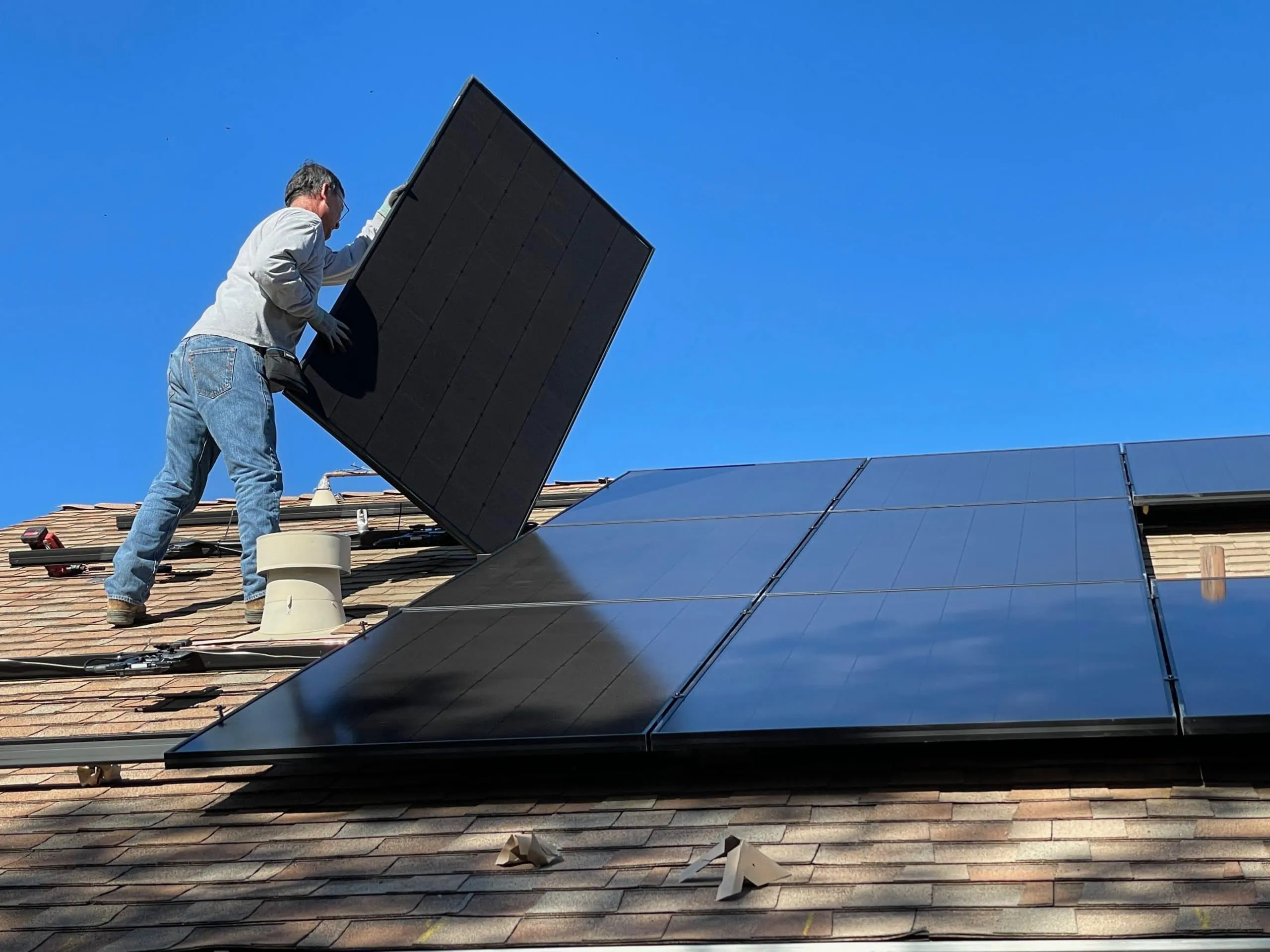 Man installing solar panel for best solar powered security cameras