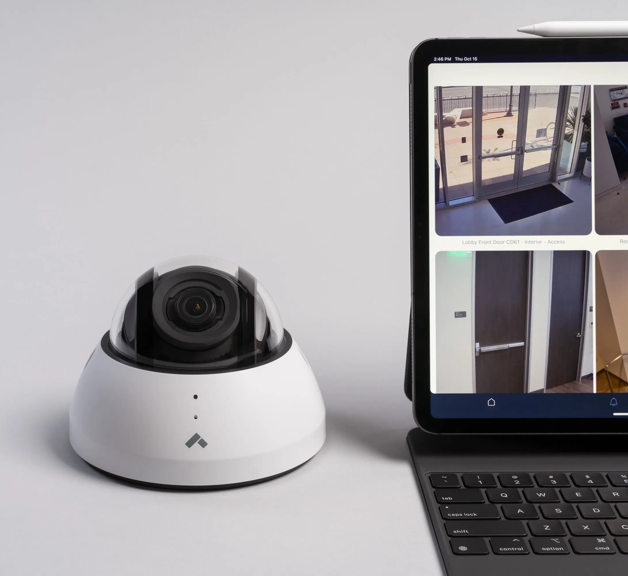Verkada dome camera part of business camera system next to laptop displaying footage