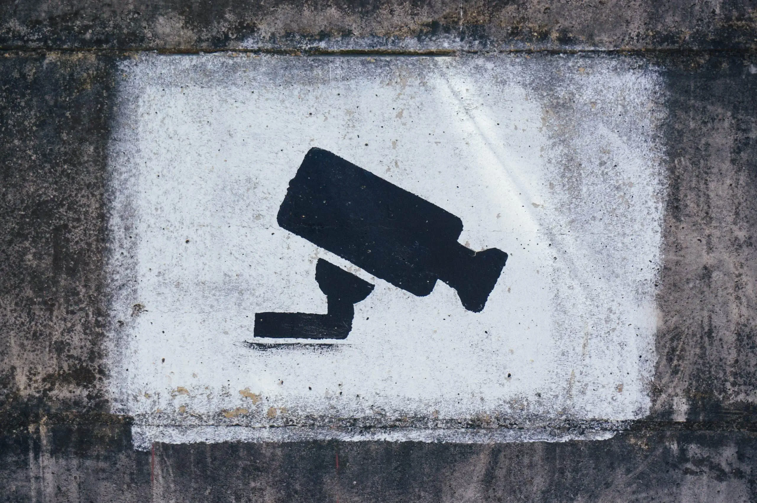 Sign indicating security camera on remote location