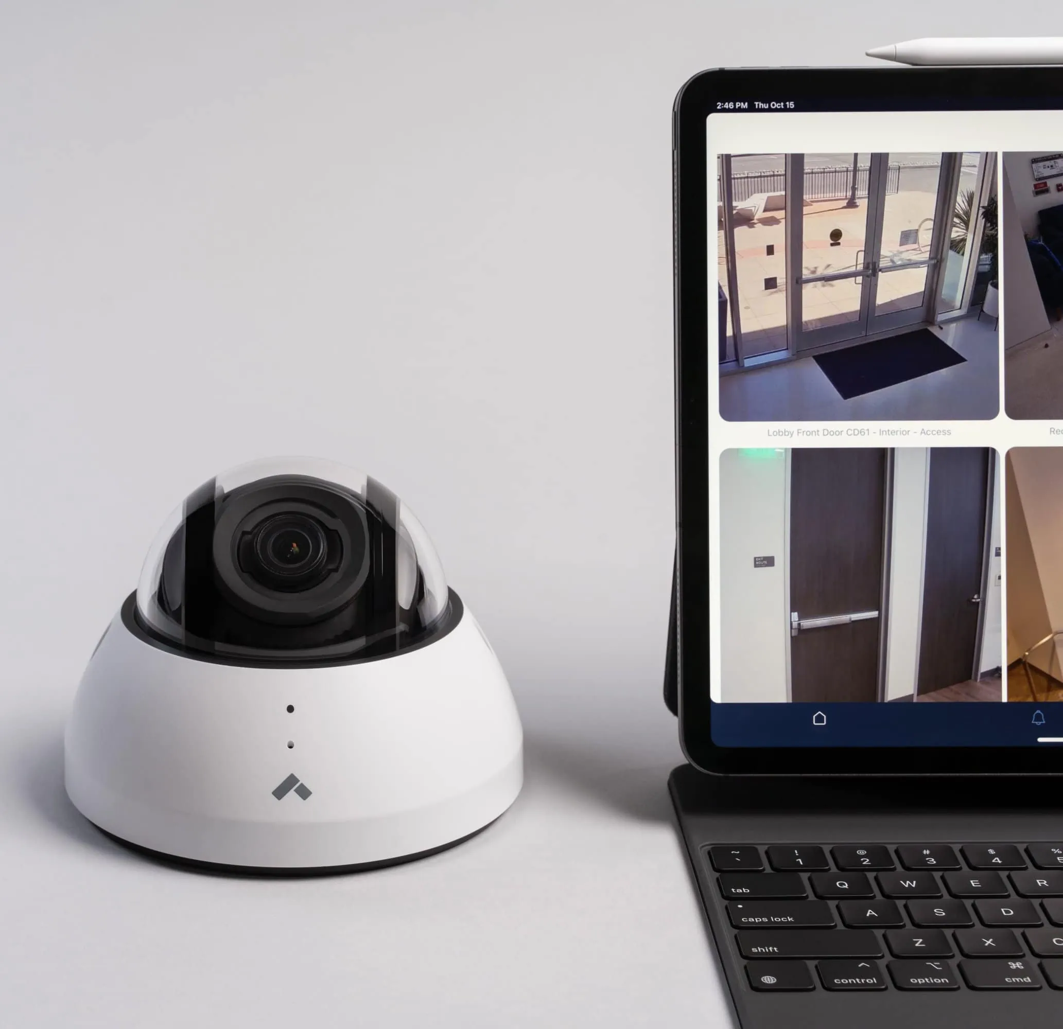 Dome security camera next to laptop displaying footage from a San Francisco business
