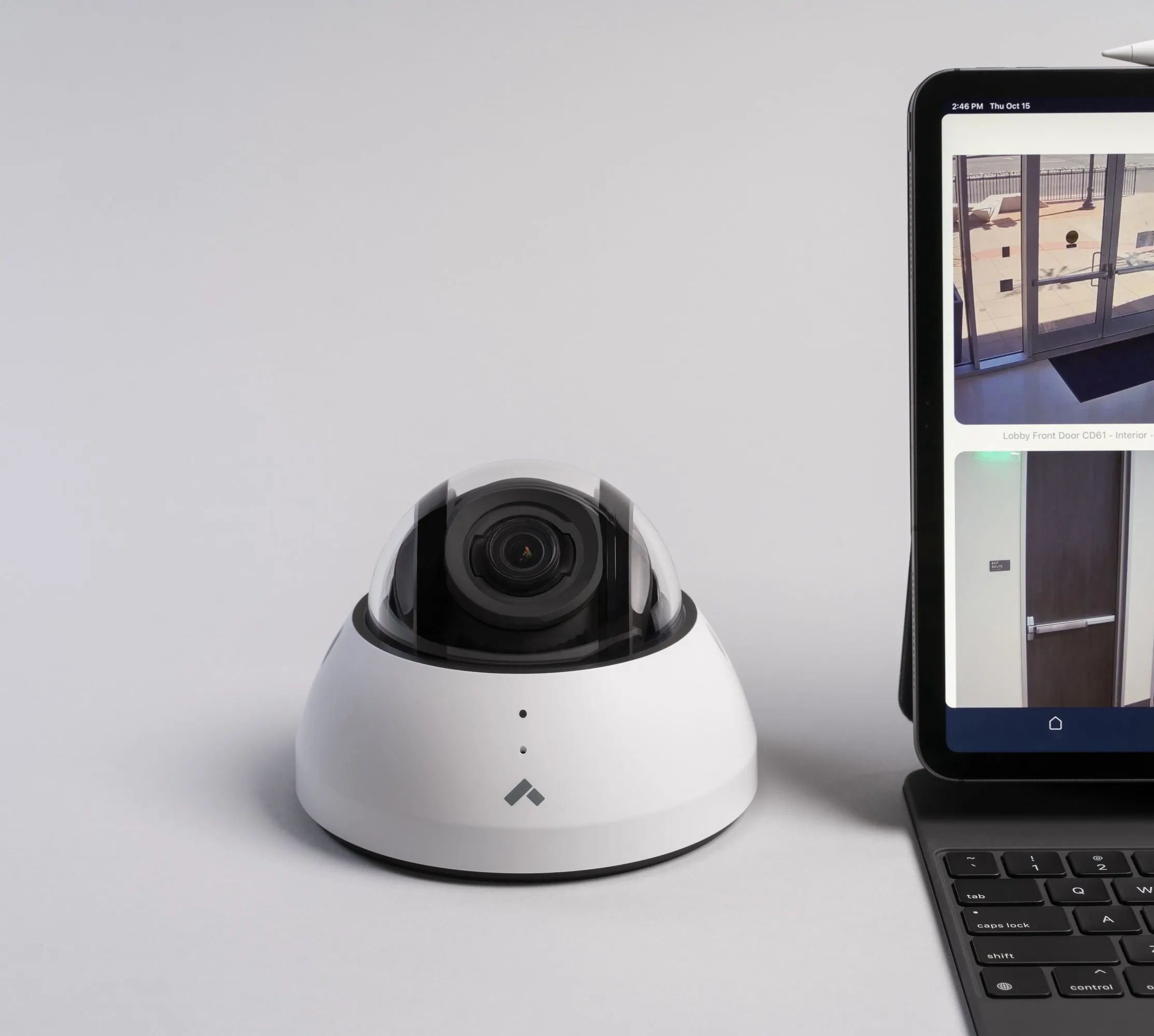 Verkada dome camera next to laptop displaying footage from a retail store with a Verkada security system