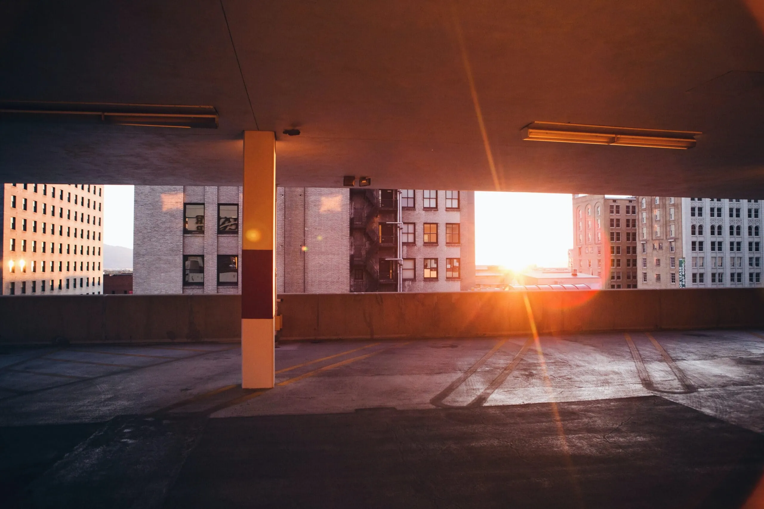 Empty parking garage with surveillance cameras at sunset