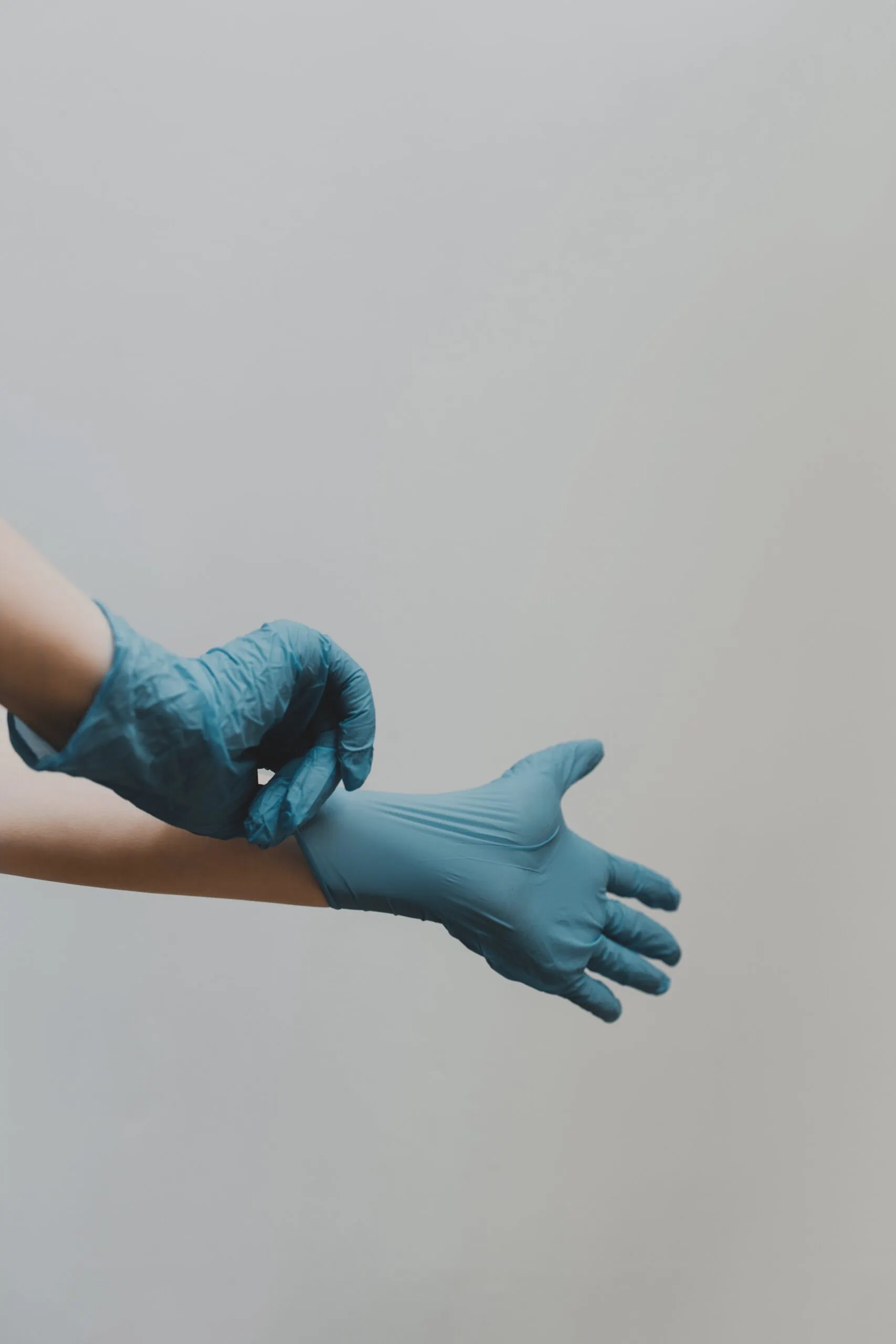 Doctor putting on gloves in hospital safe with hospital cameras