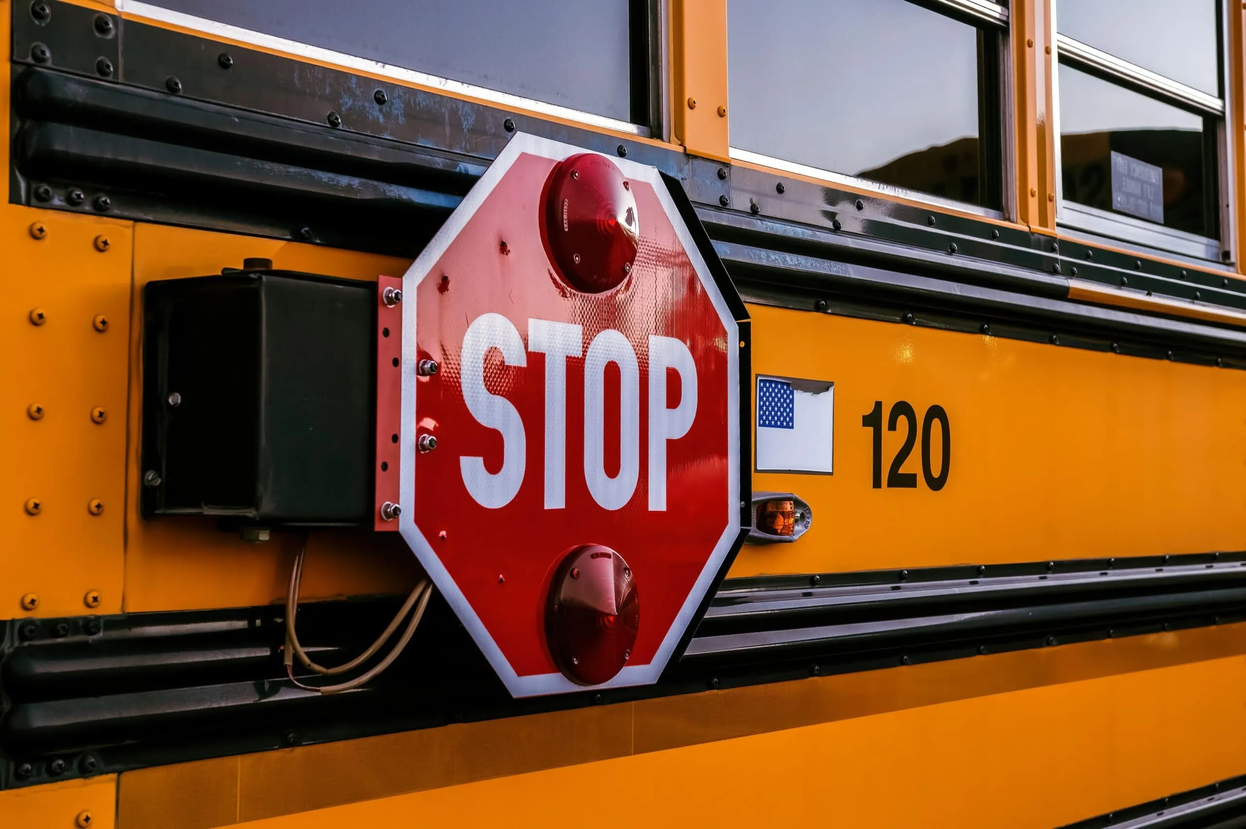 Stop sign on bus that is respected more often by other drivers now due to camera 