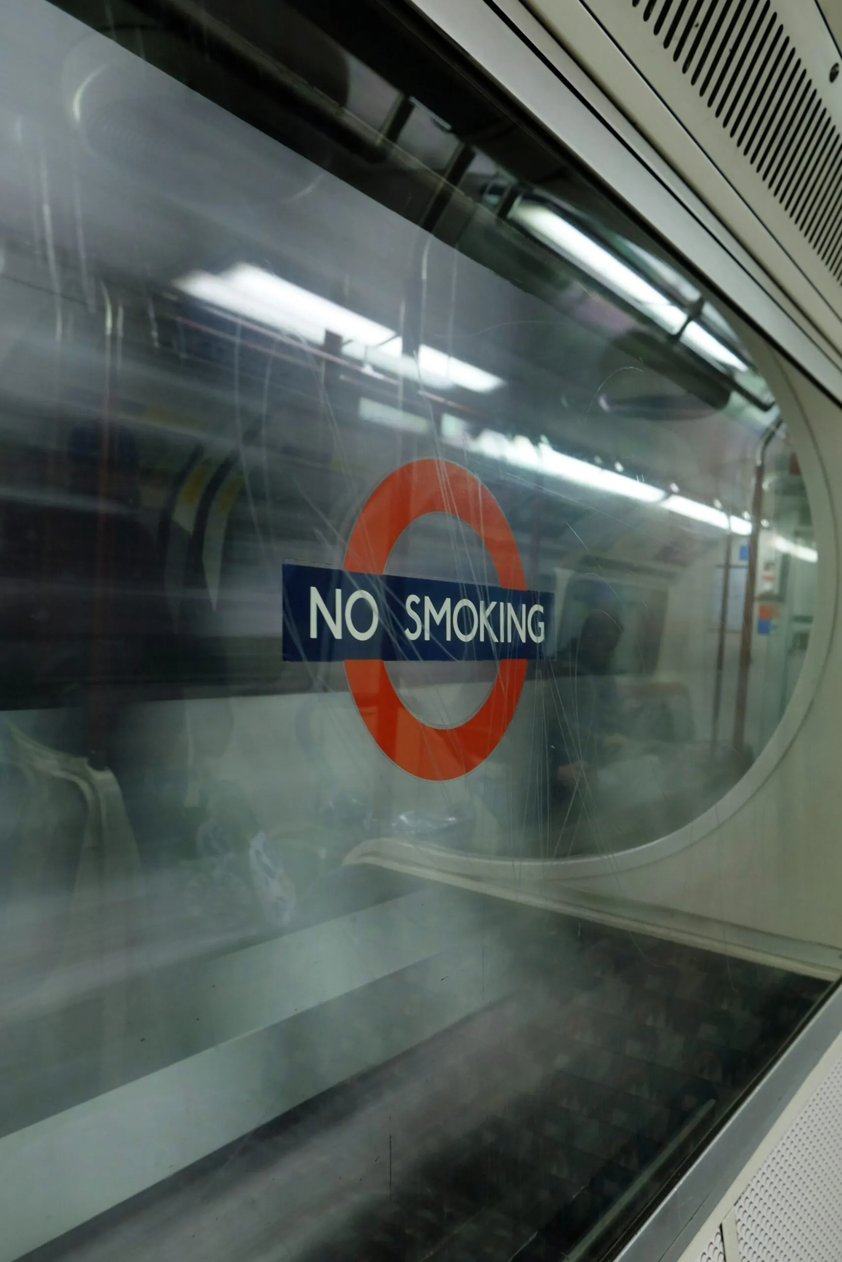 Subway window with no smoking rule displayed and reinforced by vape sensors