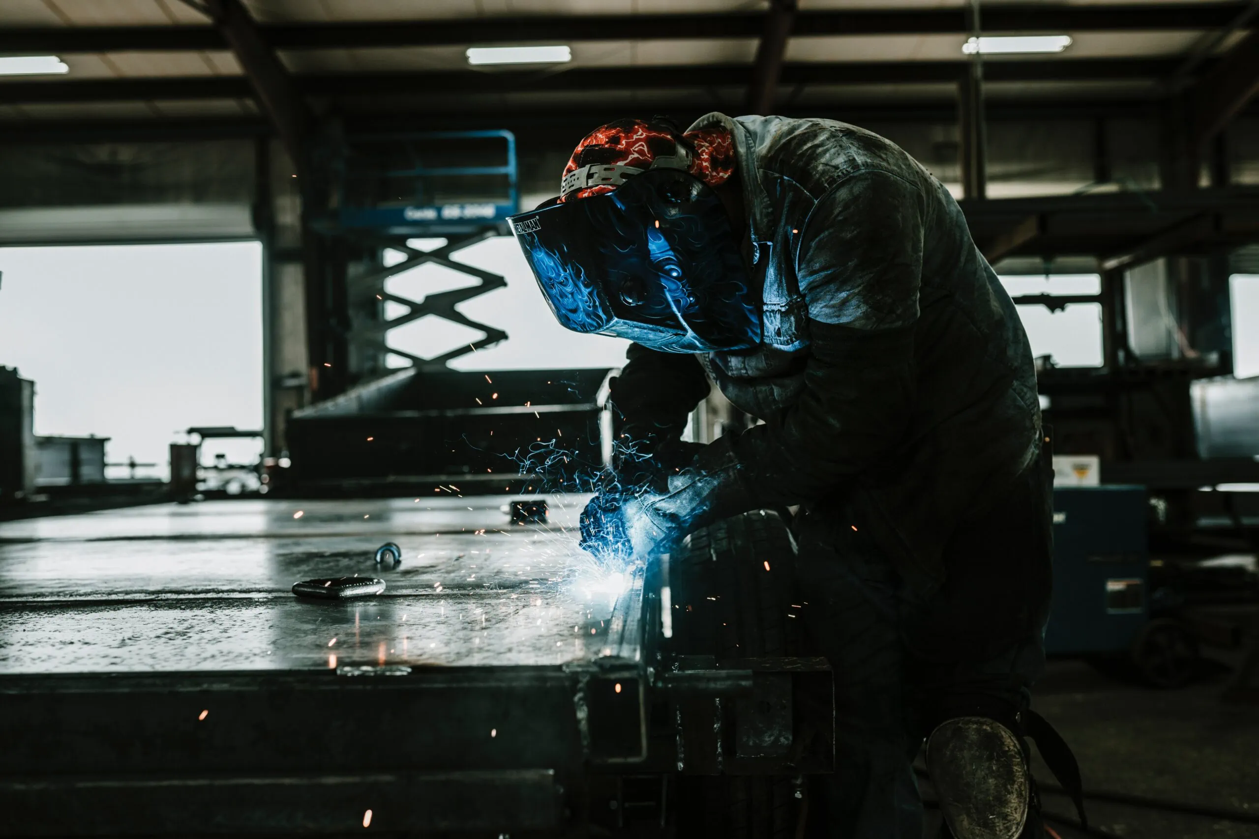 Worker welding in a manufacturing facility protected with environmental monitoring solutions