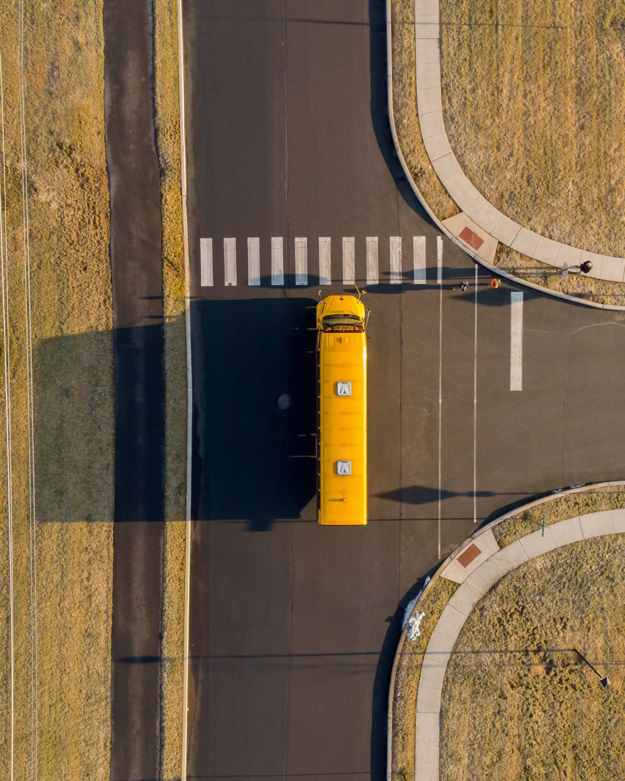 Overhead shot of school bus in route to destination, equipped with GPS tracking system