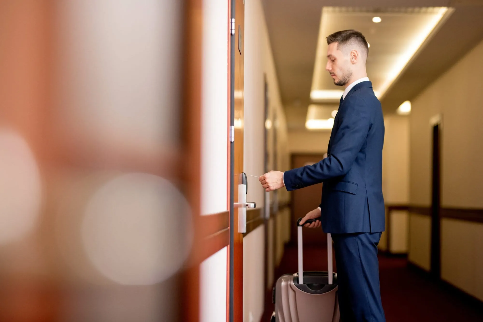 Man entering room with keycard because of door access control systems for business
