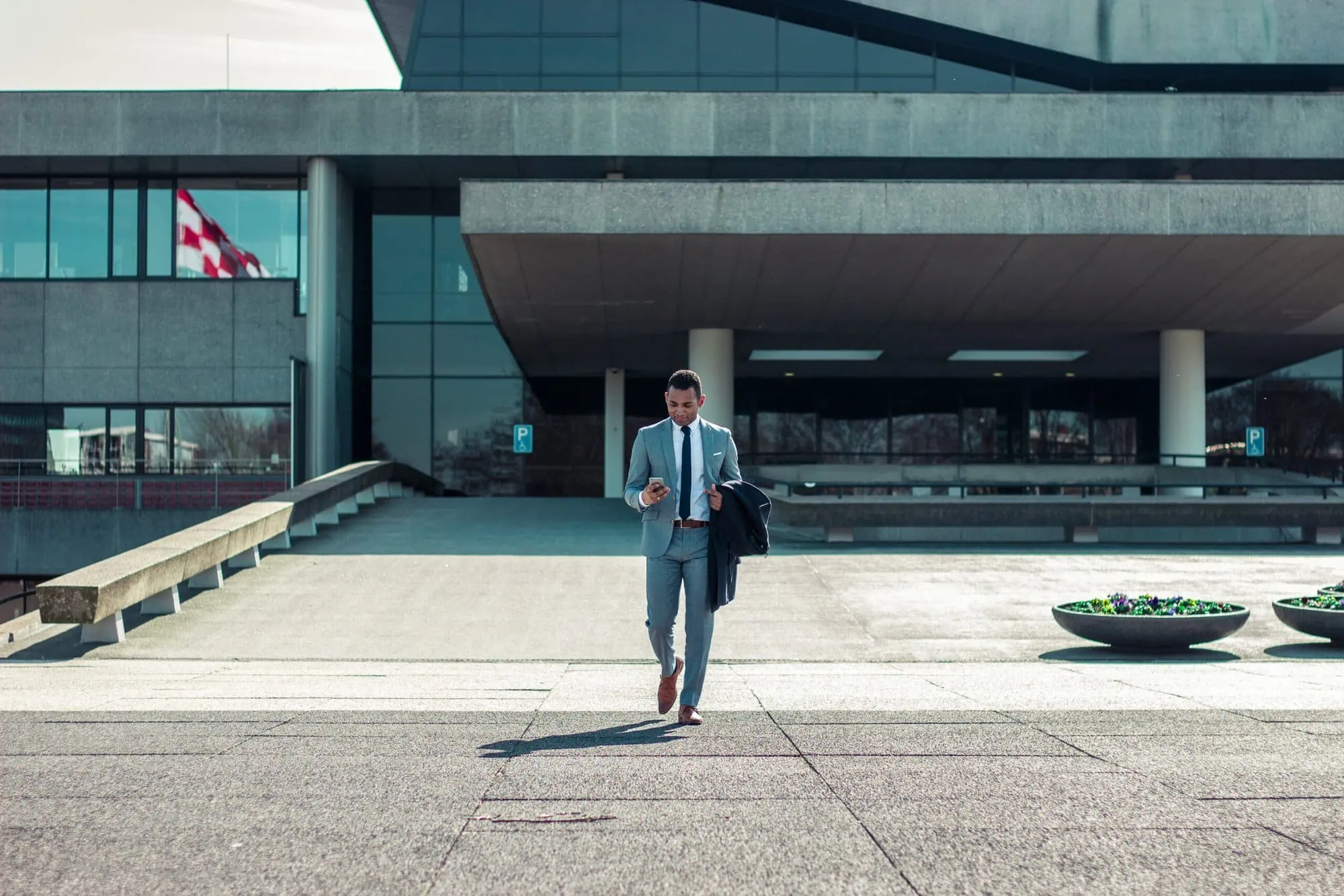 Man in suit walking out of enterprise secured with door access control systems for business