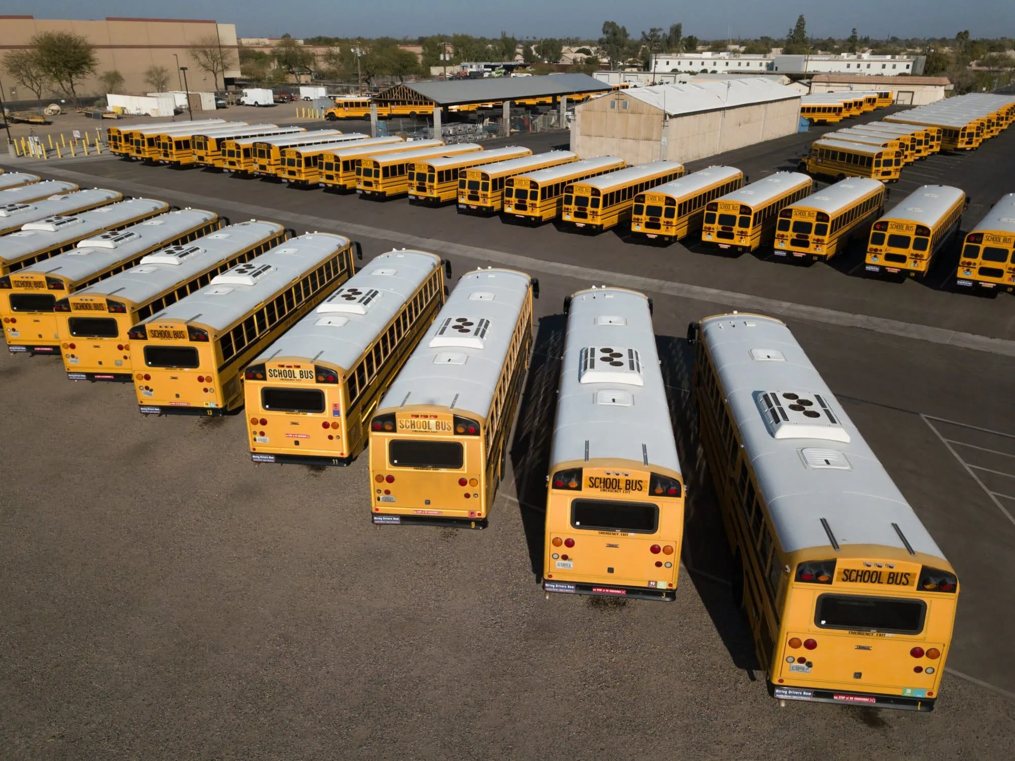 Parking lot full of school buses, all equipped with a camera system