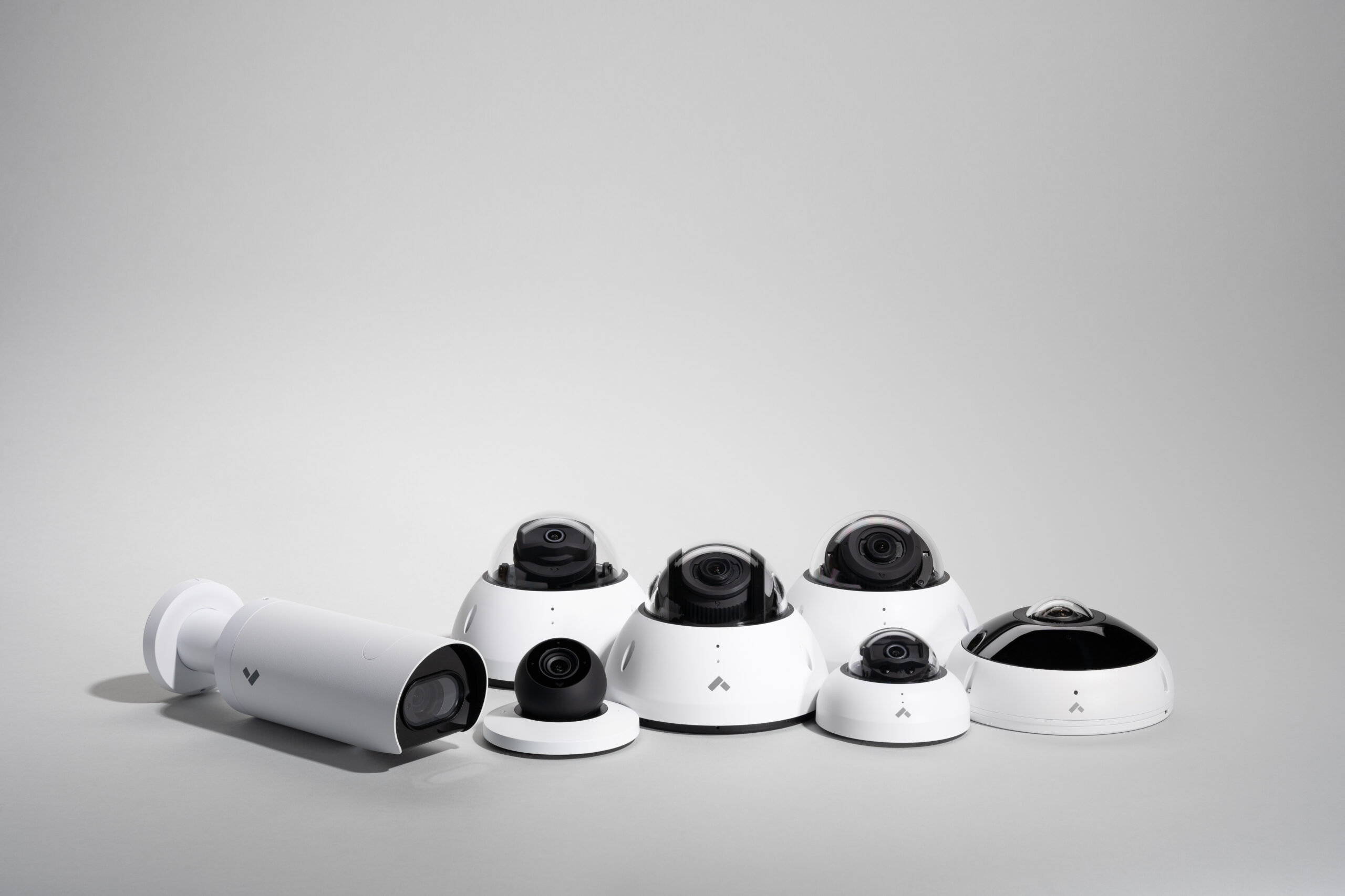 Verkada’s group of white security cameras on a grey background, ideal for storage units.